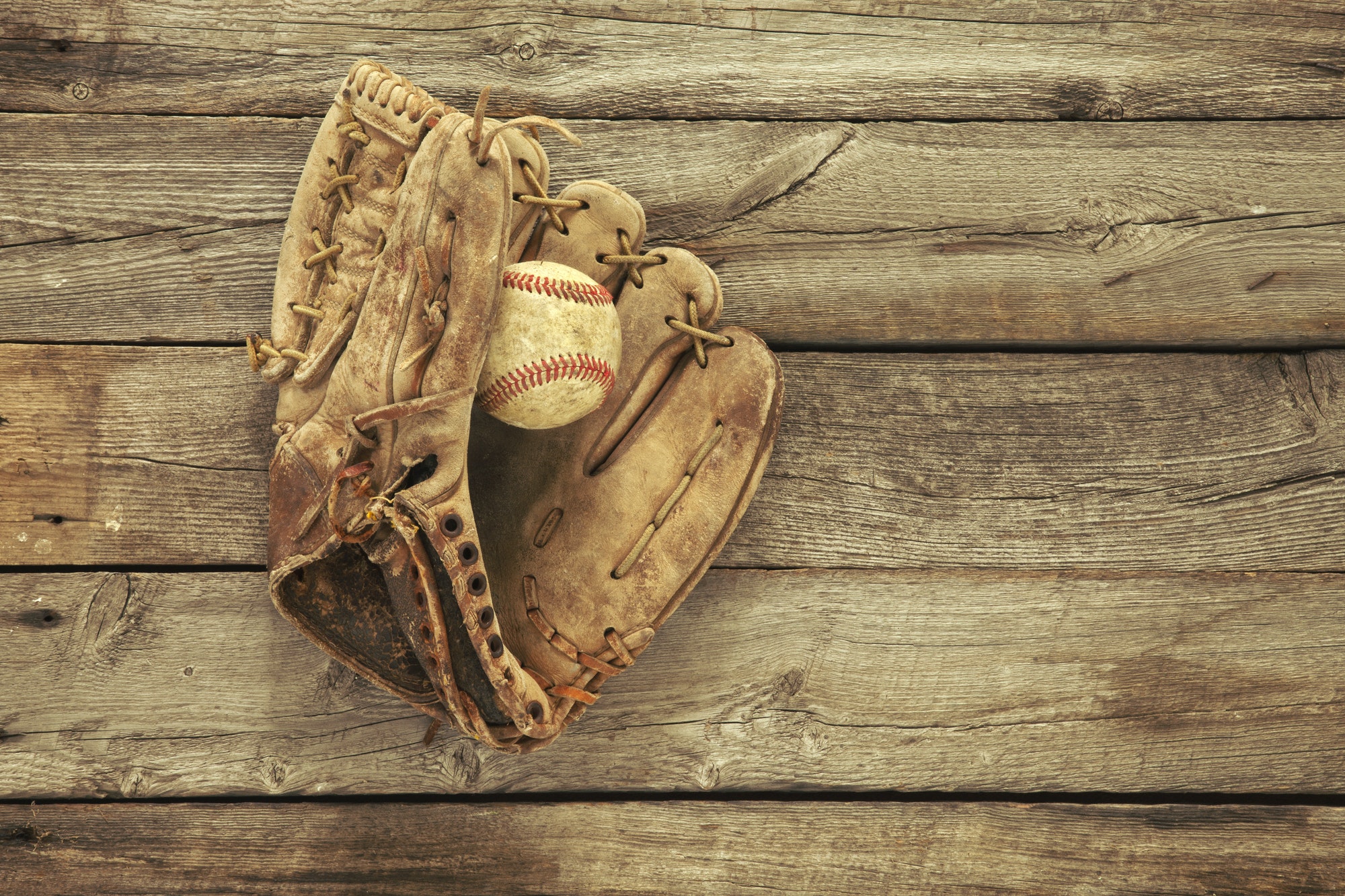 Old Baseball and Mitt on Grunge Wood Background